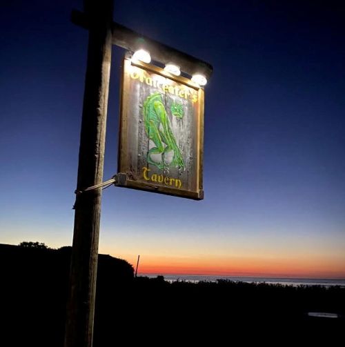 Smuggler's Tavern sign at sunset