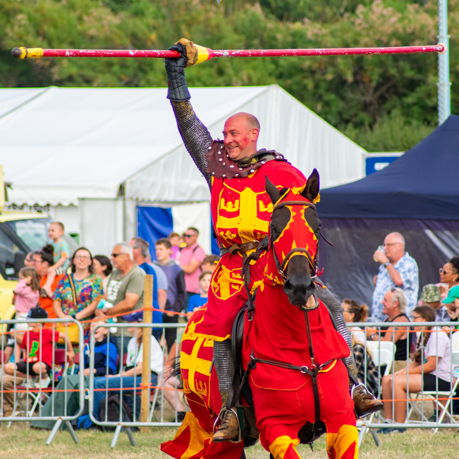Jousting knight in red and gold at the show